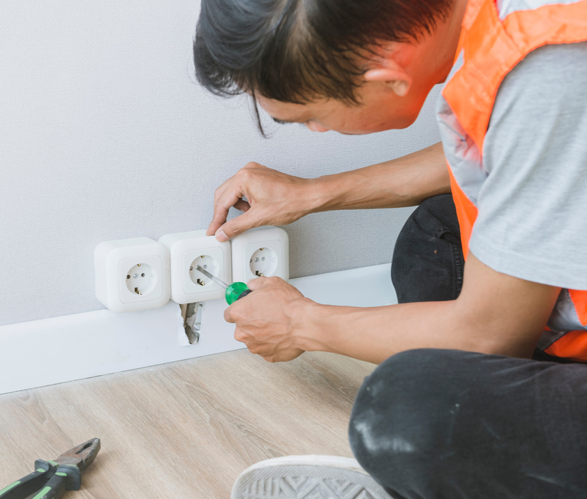 Man Installing Electrical Sockets in a Residential Unit